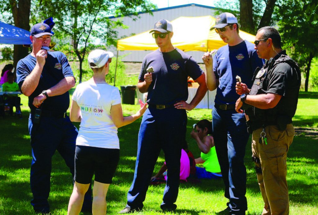Walla Walla firefighters enjoy some of the free ice cream at one of the city’s block parties while connecting with residents. (Photo provided)