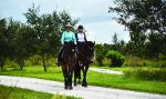 Horses are big business in Wellington, Fla., providing a boost to the local economy. Pictured are two riders enjoying the village’s Environmental Preserve Horse Trail. (Photo provided)