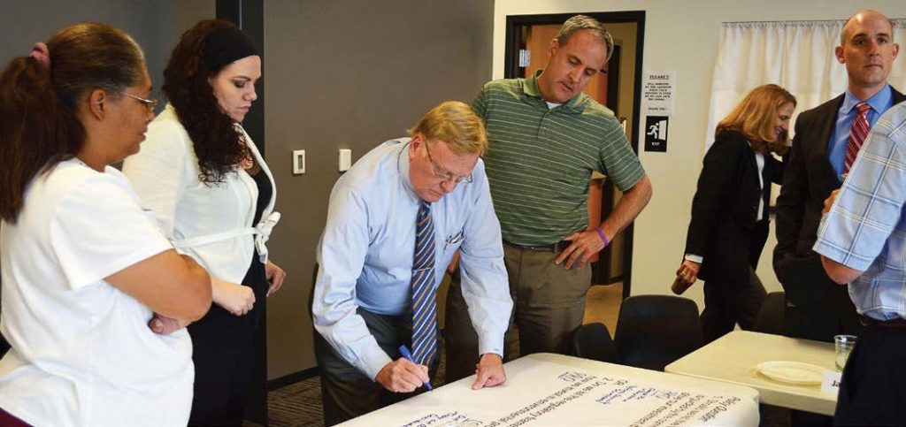 Director of Environmental Services Errin Kemper is shown standing on the right — wearing a blue shirt and red tie — listening to a member of the environmental priorities task force during one of the planning sessions to develop the city’s integrated plan for environmental issues. (Photo provided)