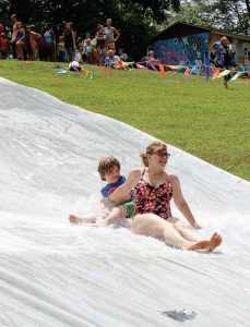 Kids enjoy a Slip ‘N Foam slide, which had been set up at Reverend Ernest D. Butler Park. (Photo provided)