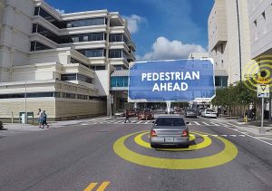 As pedestrians cross East Twiggs Street using the mid-block crosswalk at the Hillsborough County Courthouse, approaching drivers whose cars are equipped with CV technology will receive an alert that a pedestrian is in their path. (Photo provided)
