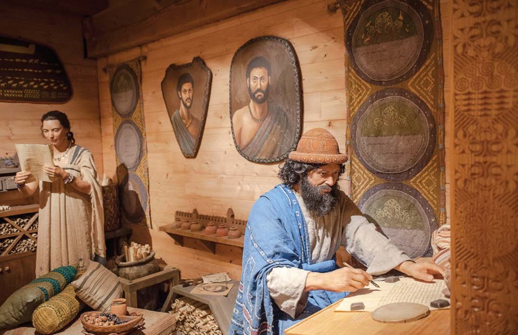 In one of several dioramas in the ark, Noah records an entry in his captain’s log as his wife reads a parchment.