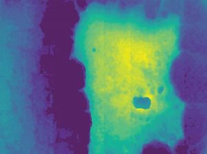 These images show what a pothole will look like on the system when detected. In the raw data, the green and yellow shows a pothole on a road. In the system, the pothole is shown by the white area. (Photo provided)