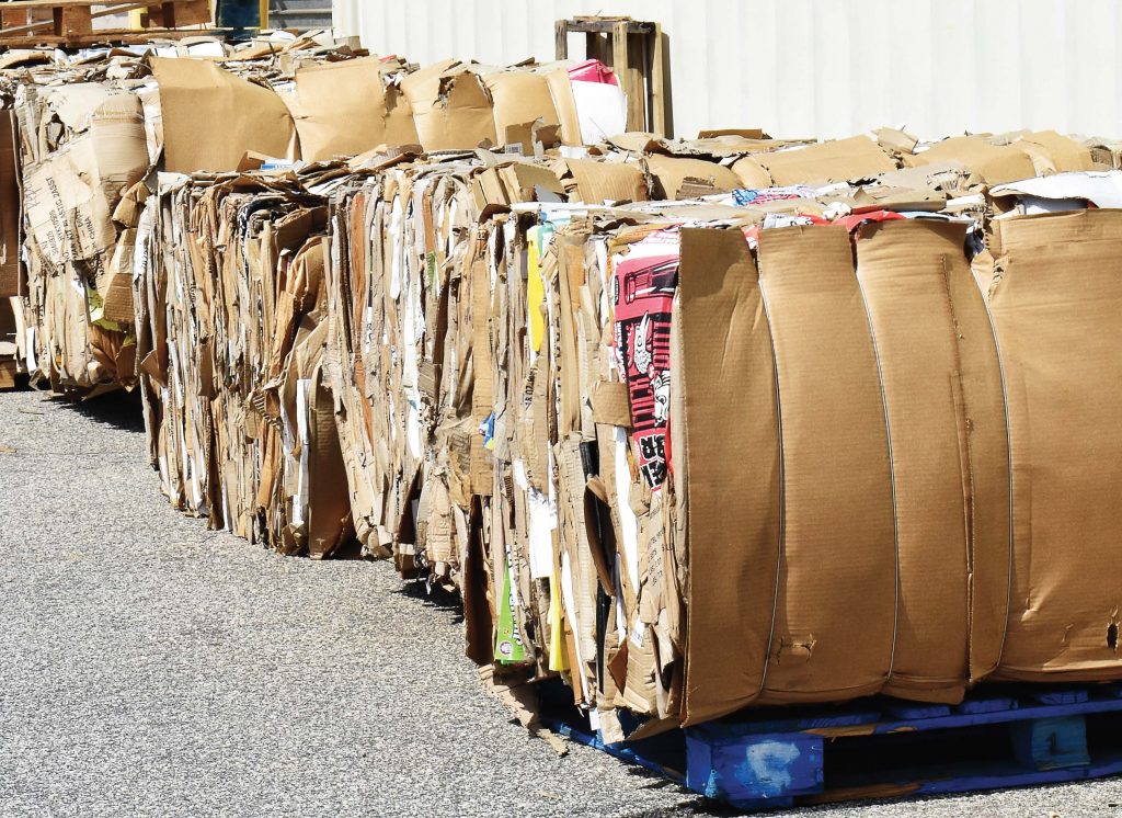 Large bundles of compressed cardboard await pickup in Greenville, S.C. Many recycled materials in the U.S. are exported to China and other countries to be made into other products. (Alan Stoddard/Shutterstock. com)