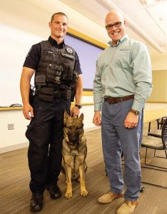 Meeting with city employees is another important aspect of Spurgeon’s career as city manager. He enjoys helping them reach their own career goals. Pictured, from left, are Officer Mike Ryan, K9 Thor and Spurgeon. (Photo provided)