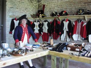 A Fort Gaines re-enactor displays colonial apparel and other memorabilia.