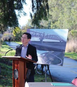 Ed Shikada speaks at a ceremony where the city of Palo Alto signed agreements for a new pedestrian and bike bridge on Dec. 17, 2018. (Photo provided)