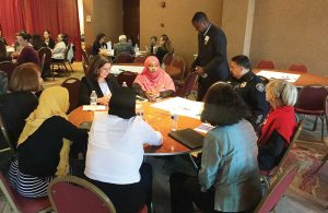 A group of diverse people gather at a community planning forum sponsored by Welcoming San Diego. There they work on ideas to make San Diego a welcoming city for immigrants. (Photo provided by Welcoming San Diego)