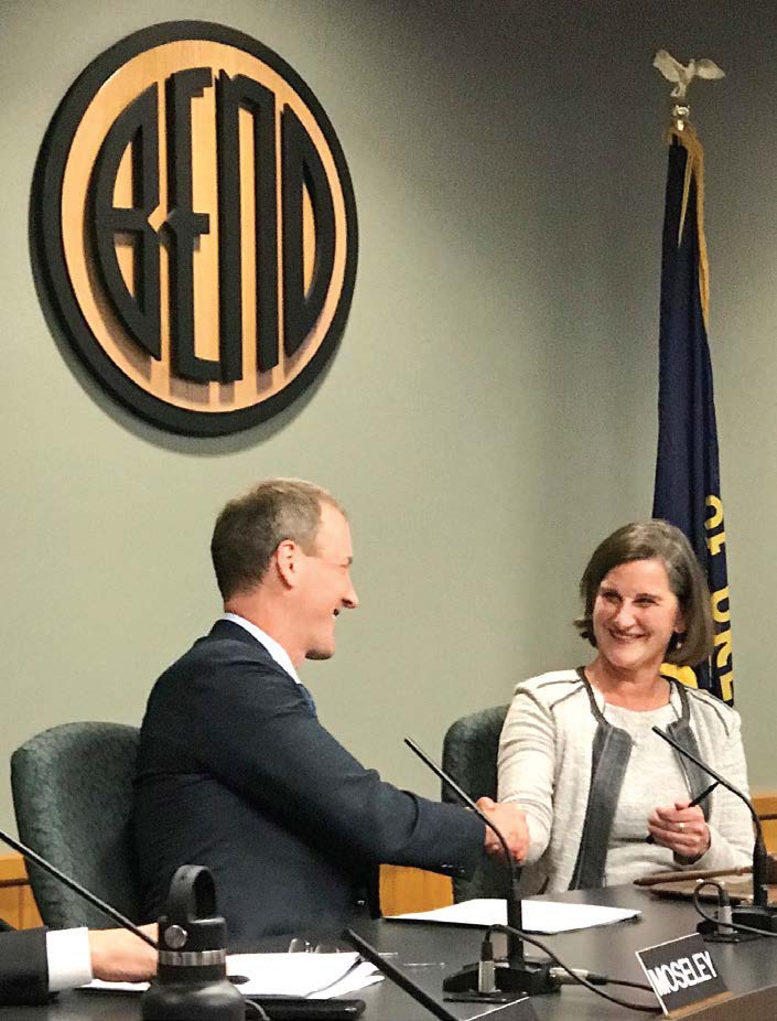 Bend, Ore., Mayor Sally Russell shakes hands with City Councilor Bill Moseley. (Photo provided)